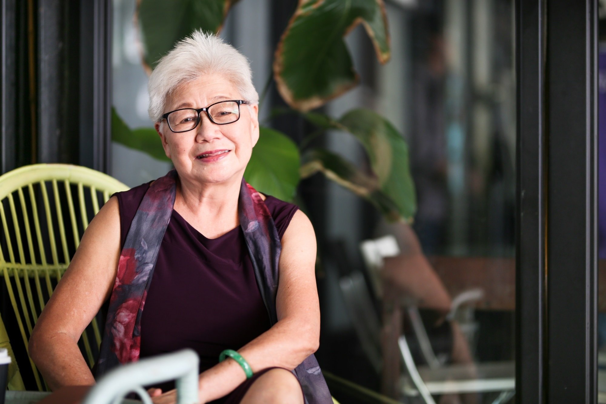 Asian older woman sit and smiling sized