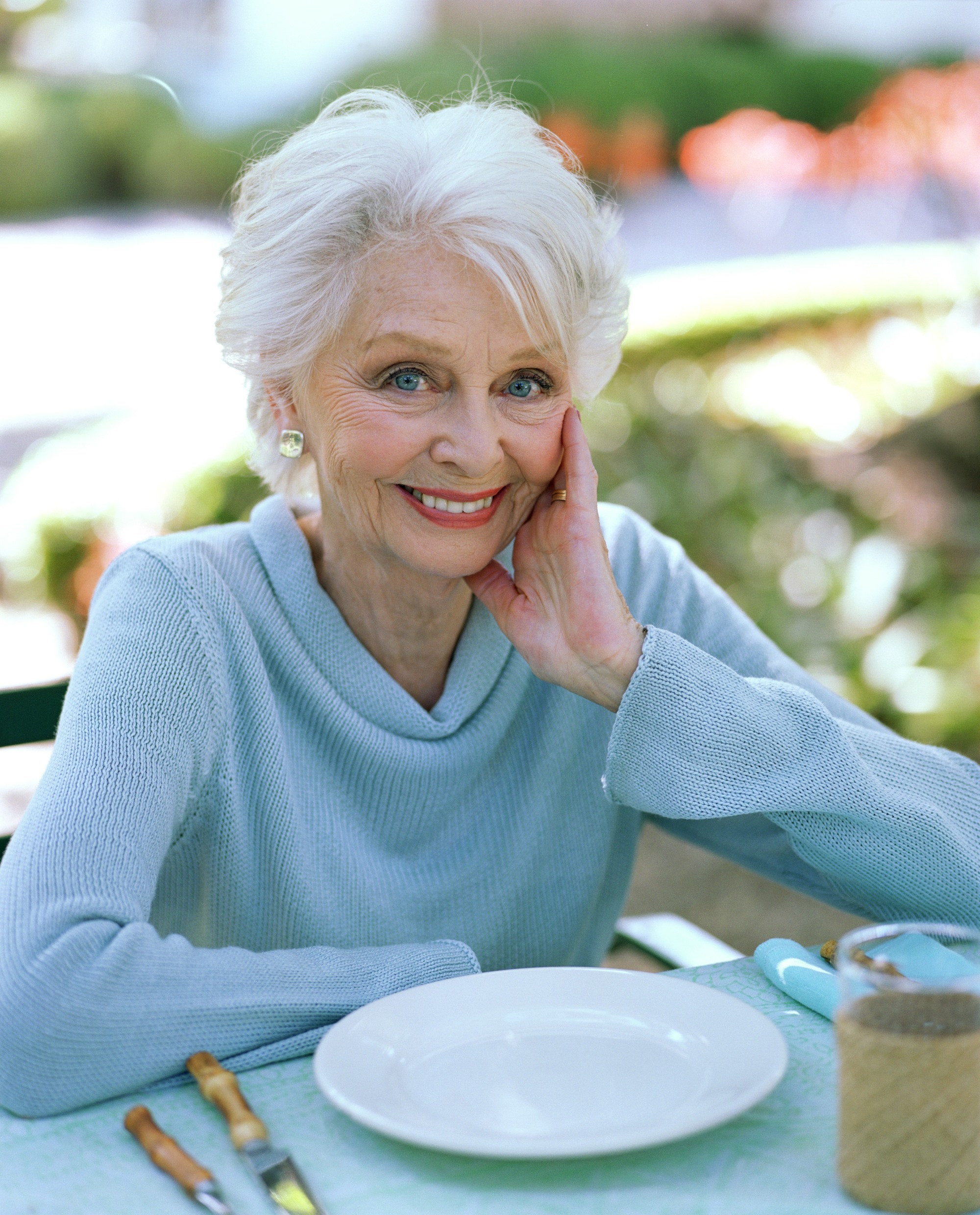 Older woman with blue sweater sized