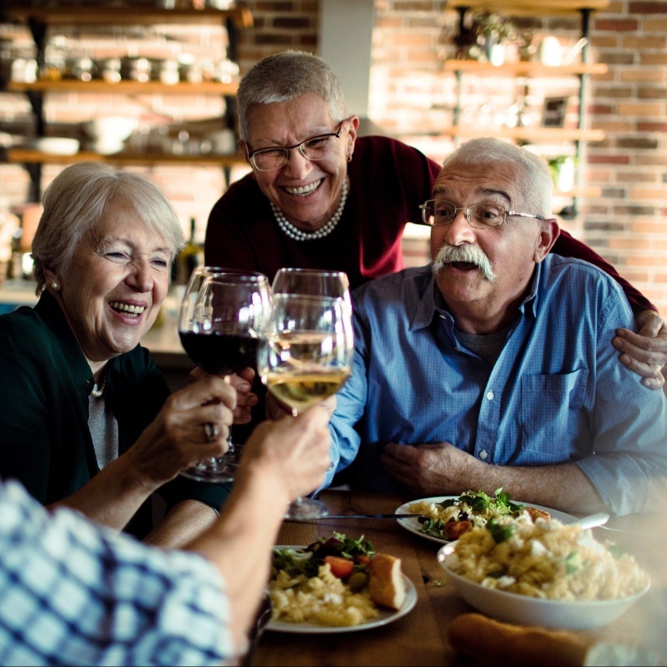 senior friends dining wine