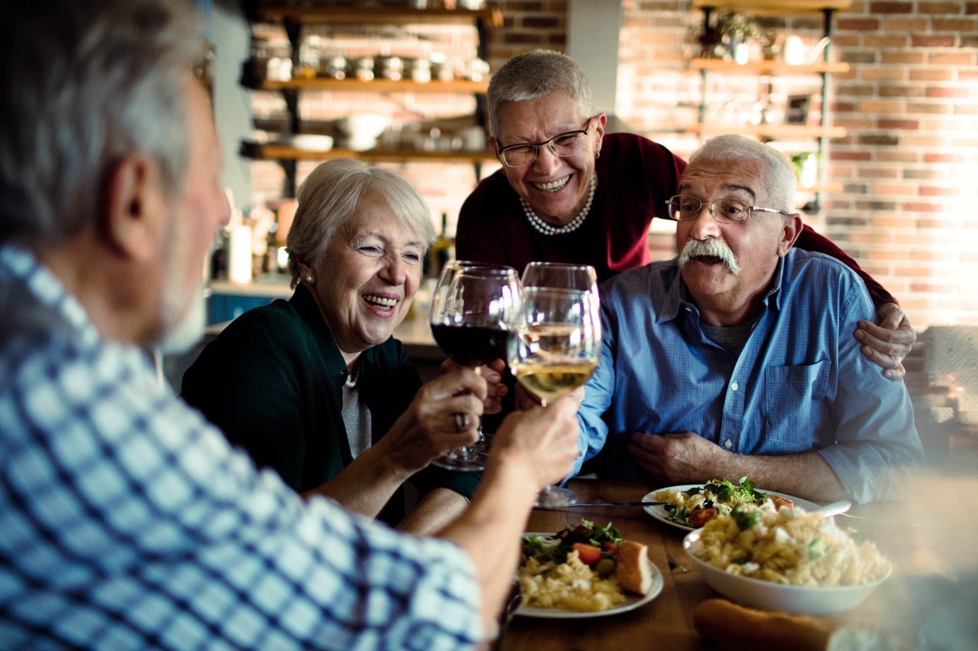 senior friends dining wine