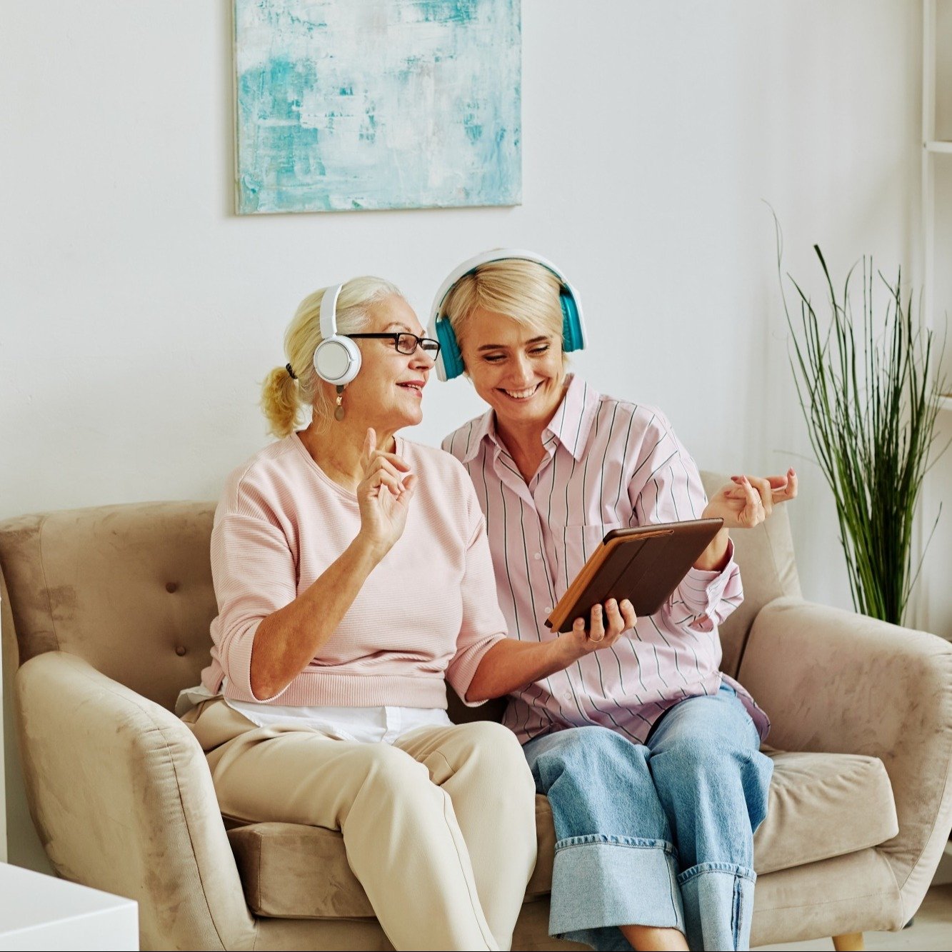 woman and younger woman listening to music